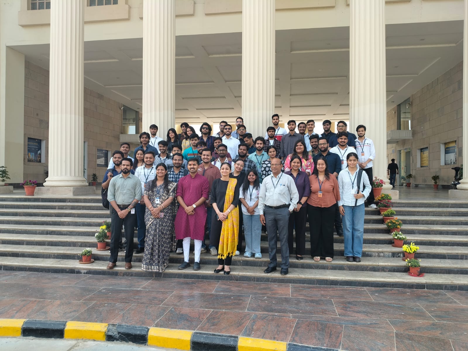 Group photo with students and faculty on the Amity University steps