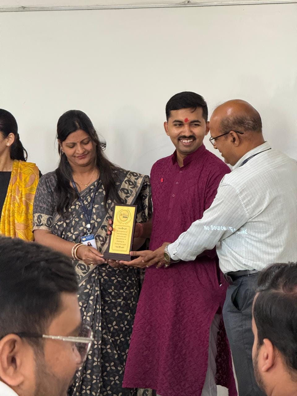 Receiving memento from Amity University faculty